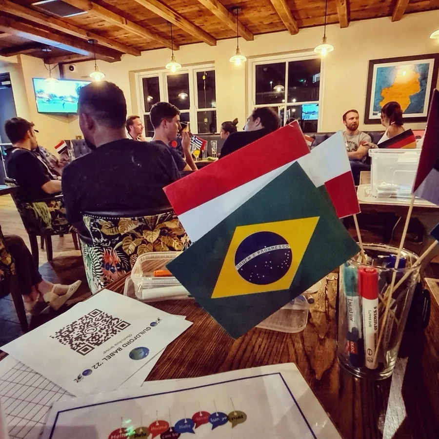 Flags of Brazil, Italy and more on a table at a Guildford Babel evening